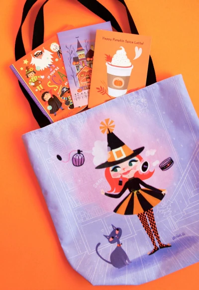 Lilly Witch tote bag
Shop the Lilly Witch tote bag
[Also pictured, If You’re Scary And You Know It board book, Jack-o-lantern House greeting card and Pumpkin Spice Latte greeting card in orange.]